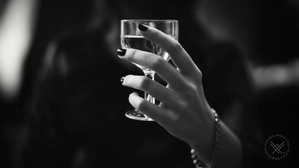 Woman holding a glass during a premium mezcal experience